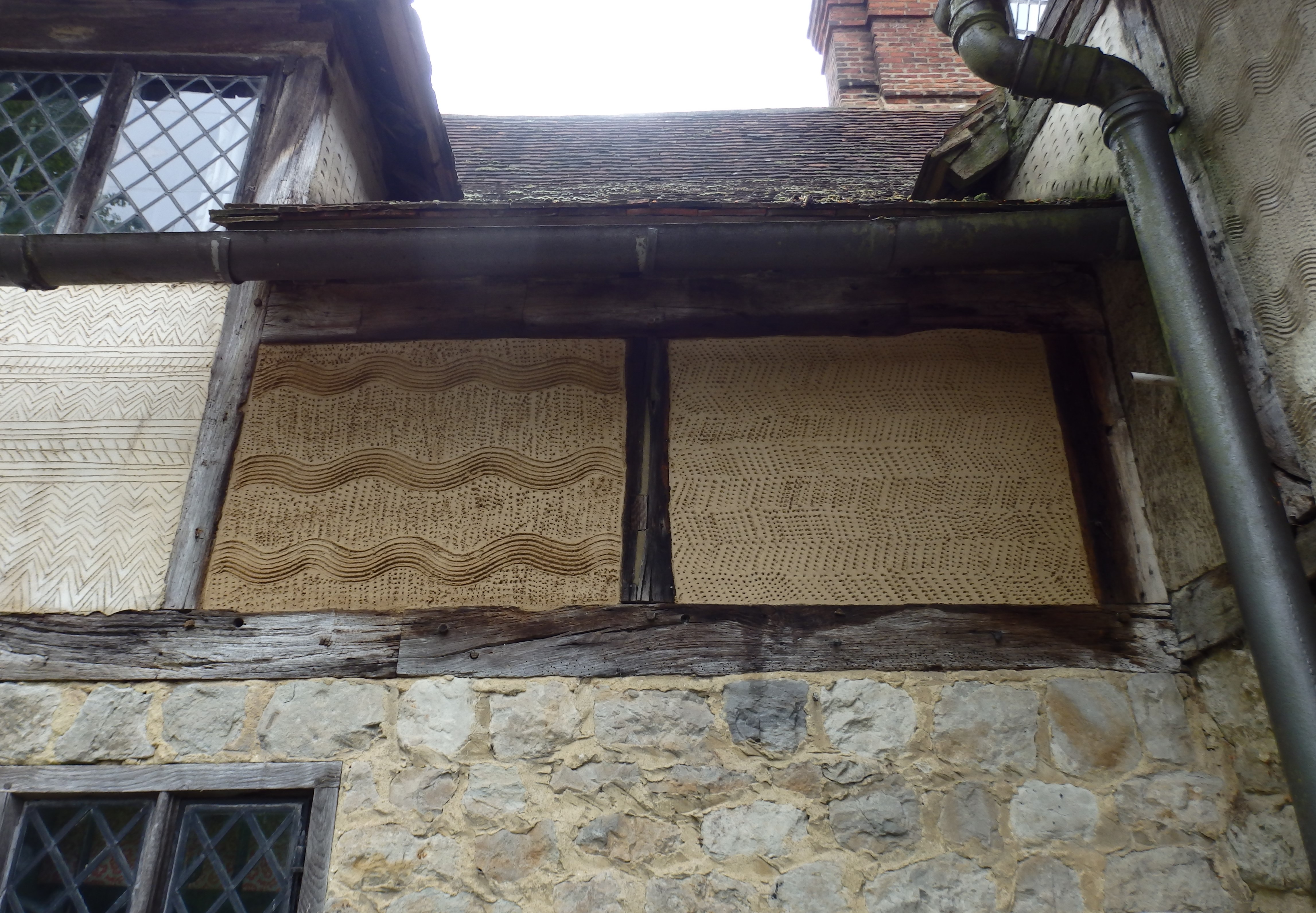 Otham Manor. A Grade 1 listed property, dating around 1370. Lime rendered panels repaired with markings.