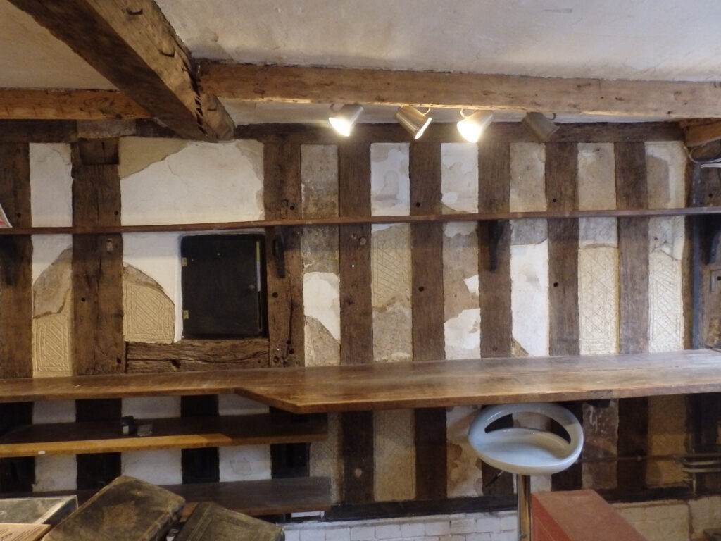 Plastering repairs to daub infill panels, using traditional lime plasters, on a timber framed house.