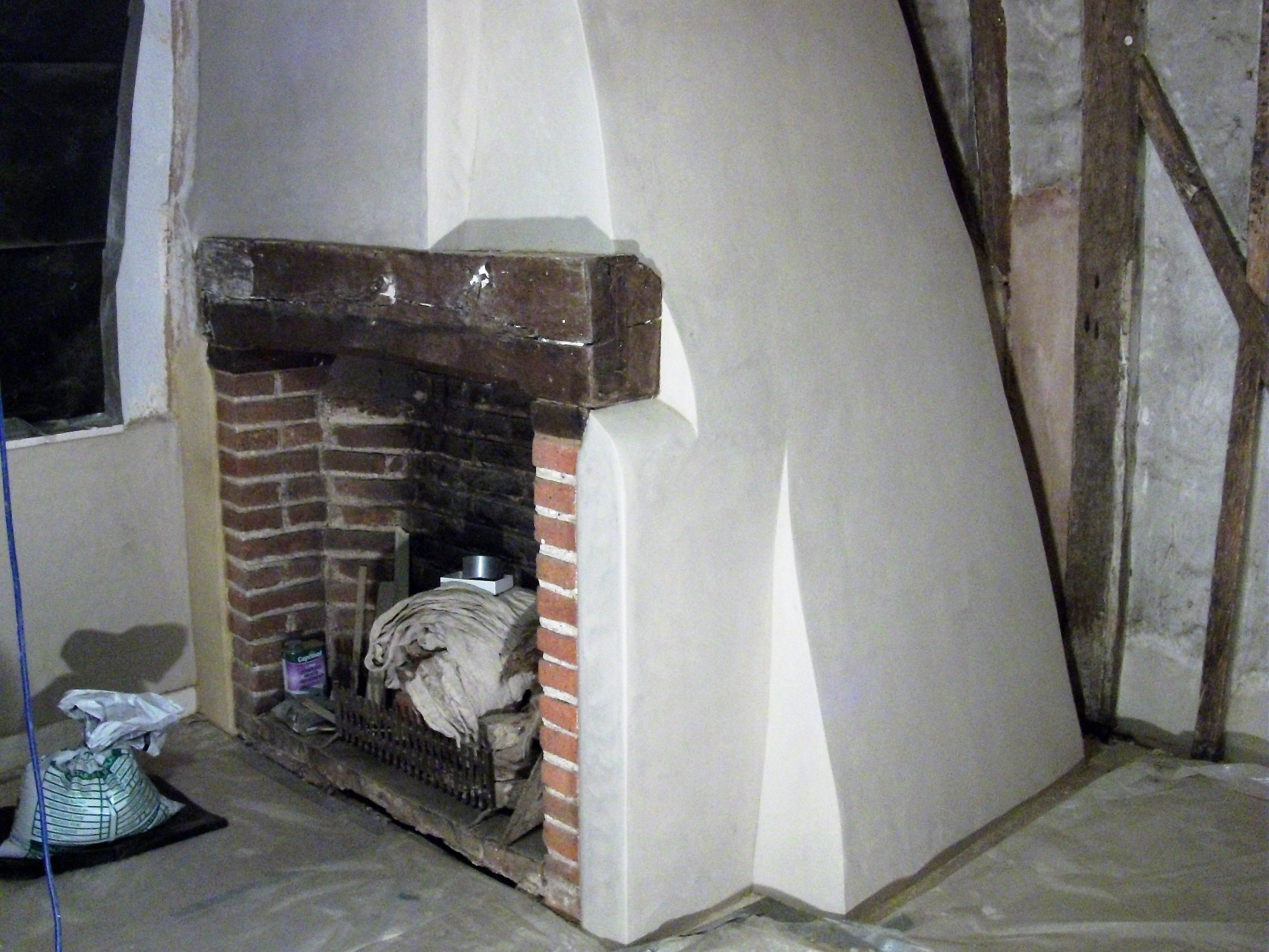 Brick fireplace plastered in lime plaster